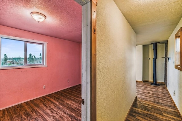 259 Falcon Rd, Como, CO 80432 - corridor with a textured ceiling, wood finished floors, a textured wall, and baseboards