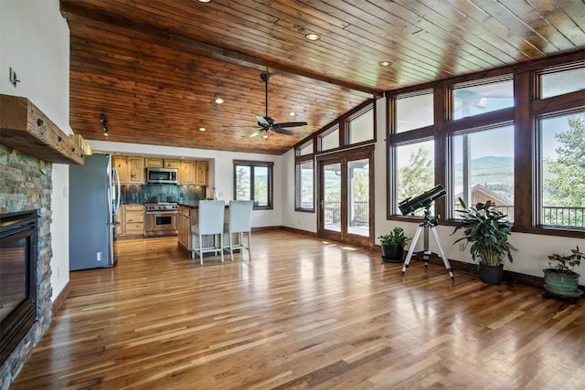 297 County Road 1012, Silverthorne, CO 80498 - living room with ceiling fan, plenty of natural light, a fireplace, wooden ceiling, and lofted ceiling