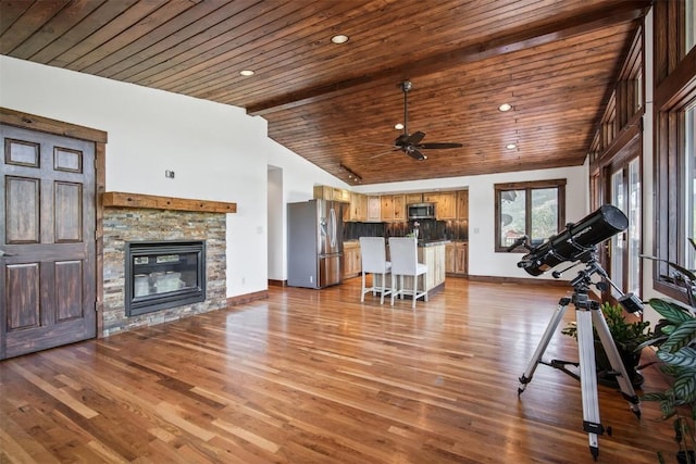 297 County Road 1012, Silverthorne, CO 80498 - exercise room with vaulted ceiling, wood ceiling, a ceiling fan, wood finished floors, and a fireplace