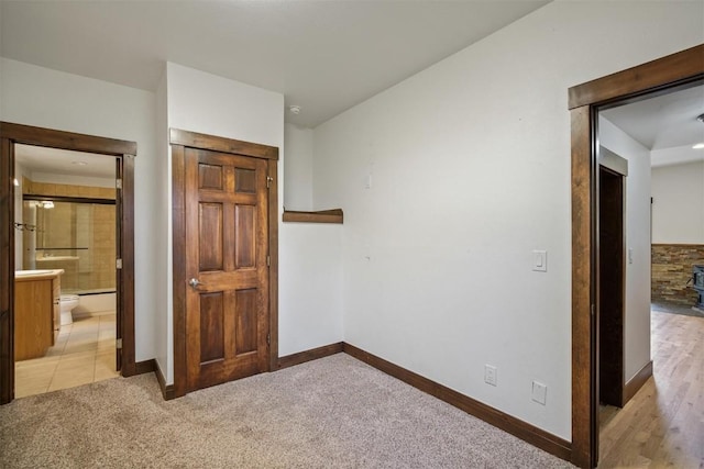 297 County Road 1012, Silverthorne, CO 80498 - unfurnished bedroom with baseboards, light colored carpet, a closet, and ensuite bath