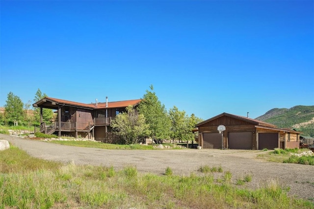 297 County Road 1012, Silverthorne, CO 80498 - view of front of home featuring a garage, a mountain view, and driveway