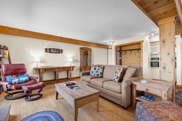 living room with baseboards and wood finished floors