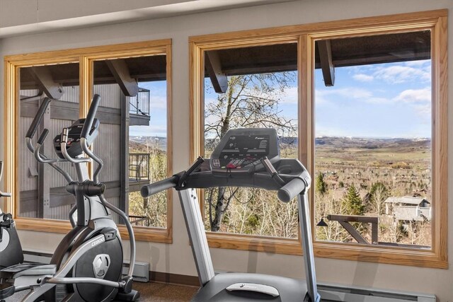 workout room with baseboards and baseboard heating
