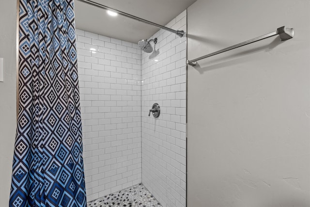 bathroom with a tile shower