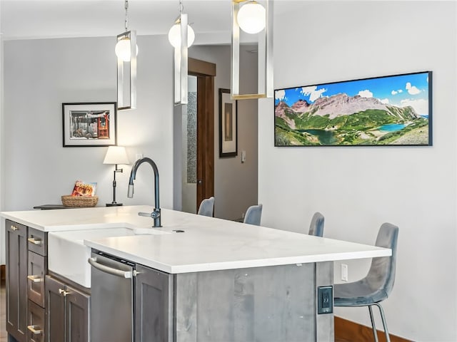 1521 Ski Hill Rd Unit 8424, Breckenridge, CO 80424 - kitchen with light countertops, stainless steel dishwasher, decorative light fixtures, and a center island with sink