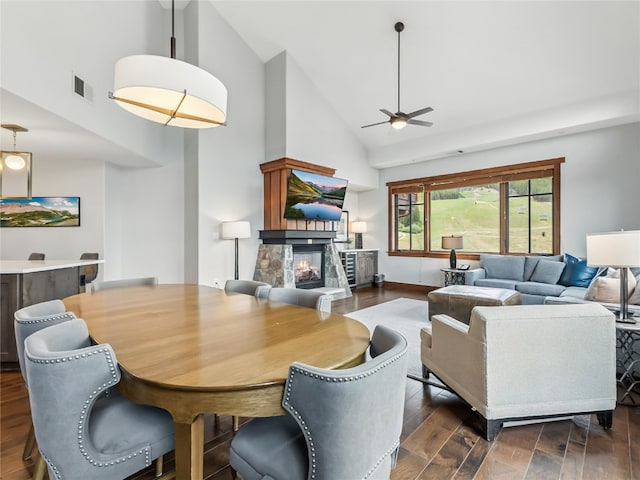 1521 Ski Hill Rd Unit 8424, Breckenridge, CO 80424 - dining area with high vaulted ceiling, a fireplace, ceiling fan, and dark wood-type flooring