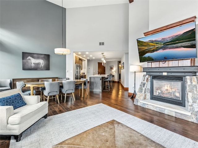 1521 Ski Hill Rd Unit 8424, Breckenridge, CO 80424 - living area with a high ceiling, dark wood-type flooring, and a fireplace