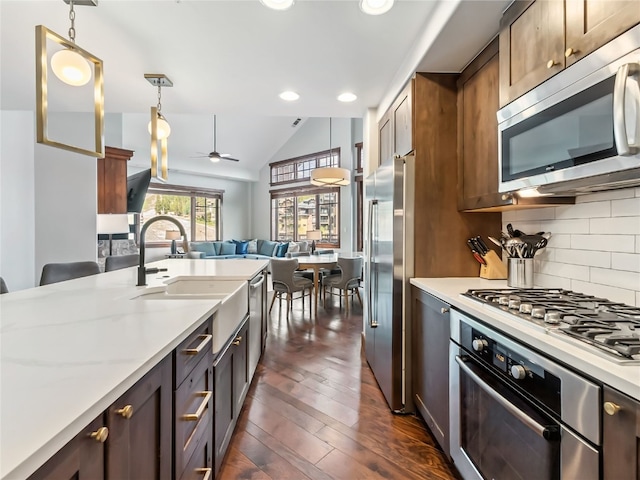1521 Ski Hill Rd Unit 8424, Breckenridge, CO 80424 - kitchen with stainless steel appliances, open floor plan, a ceiling fan, pendant lighting, and lofted ceiling