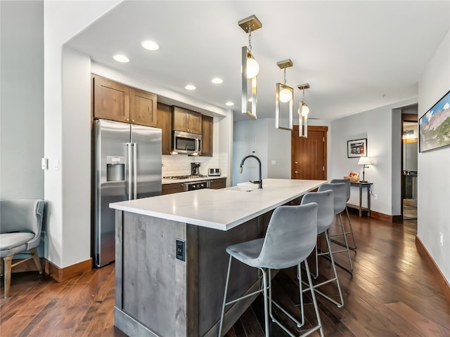 1521 Ski Hill Rd Unit 8424, Breckenridge, CO 80424 - kitchen featuring stainless steel appliances, tasteful backsplash, a center island with sink, dark wood-style floors, and recessed lighting
