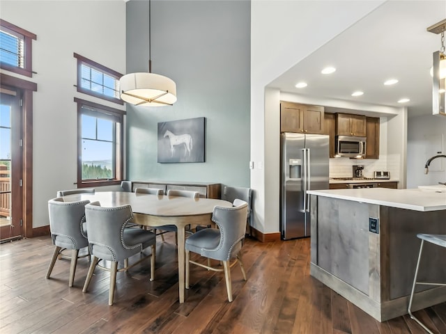 1521 Ski Hill Rd Unit 8424, Breckenridge, CO 80424 - dining space featuring a towering ceiling, dark wood finished floors, and recessed lighting
