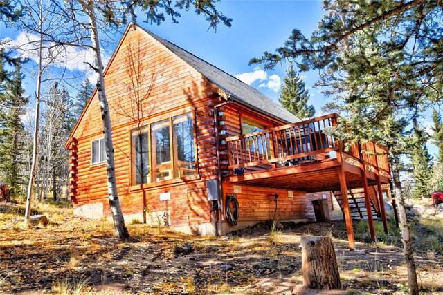 2377 Stagestop Rd, Jefferson, CO 80456 - view of side of home featuring stairway, log siding, and a deck