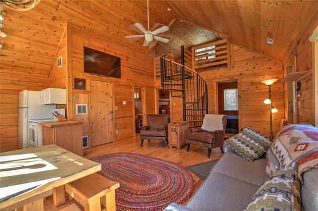 2377 Stagestop Rd, Jefferson, CO 80456 - living room with stairway, a ceiling fan, wood finished floors, wooden ceiling, and wood walls