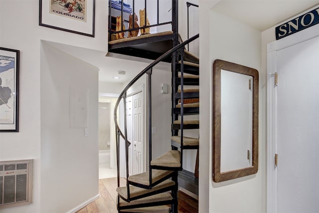 1937 Soda Ridge Rd Unit 1138, Keystone, CO 80435 - staircase featuring baseboards, wood finished floors, heating unit, and a high ceiling