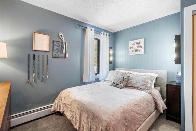 1127 Ski Hill Rd Unit 106, Breckenridge, CO 80424 - carpeted bedroom featuring a baseboard heating unit and a textured ceiling