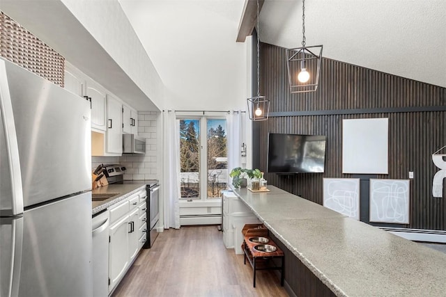 1127 Ski Hill Rd Unit 106, Breckenridge, CO 80424 - kitchen with stainless steel appliances, white cabinets, high vaulted ceiling, wood finished floors, and light countertops