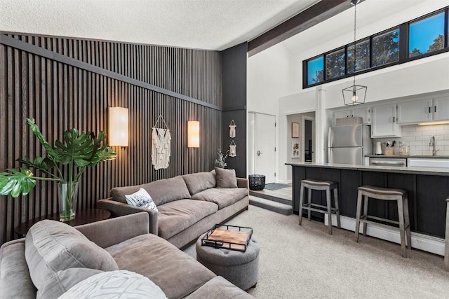 1127 Ski Hill Rd Unit 106, Breckenridge, CO 80424 - living area featuring high vaulted ceiling, light colored carpet, and a textured ceiling