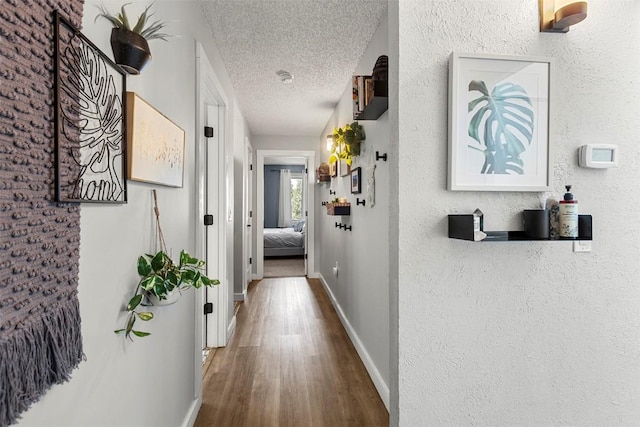 1127 Ski Hill Rd Unit 106, Breckenridge, CO 80424 - hall with a textured ceiling, wood finished floors, and baseboards