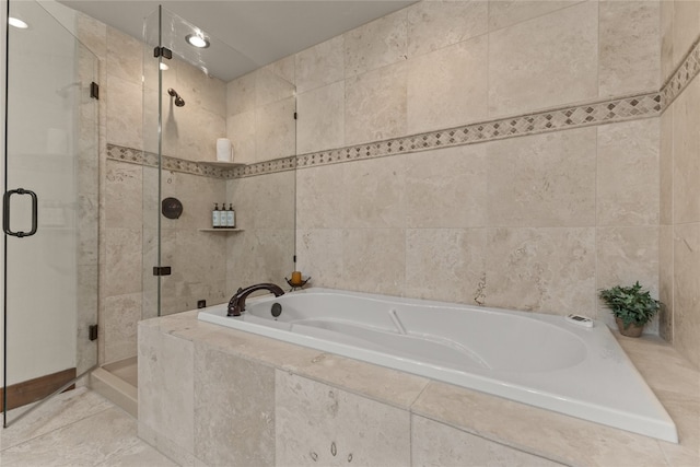 1800 Medicine Springs Dr Unit 5303, Steamboat Springs, CO 80487 - bathroom featuring a garden tub, a shower stall, and tile walls