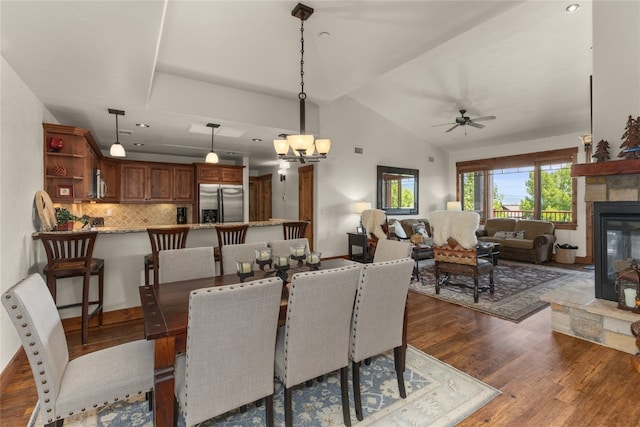 1800 Medicine Springs Dr Unit 5303, Steamboat Springs, CO 80487 - dining area with dark wood finished floors, a ceiling fan, a fireplace, lofted ceiling, and a chandelier