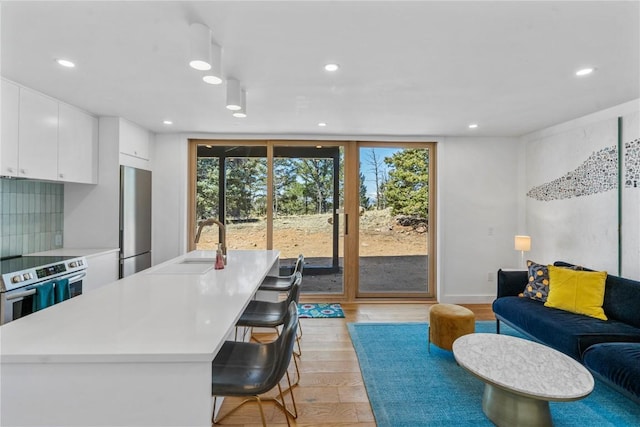 interior space with light wood finished floors, plenty of natural light, and recessed lighting