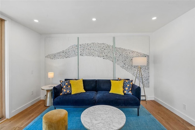 living area featuring baseboards, wood finished floors, and recessed lighting