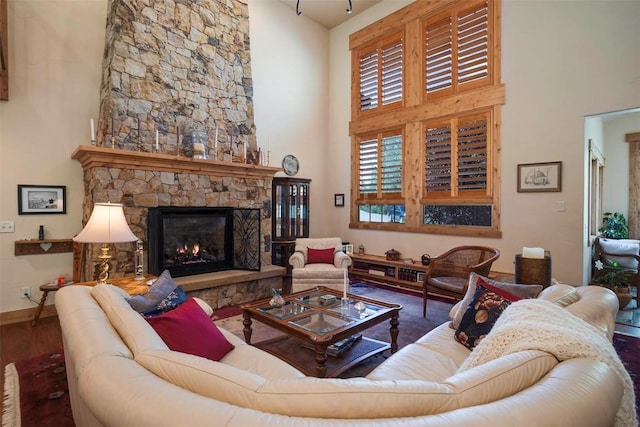 2415 Val Disere Cir, Steamboat Springs, CO 80487 - living area with a towering ceiling, a stone fireplace, and wood finished floors