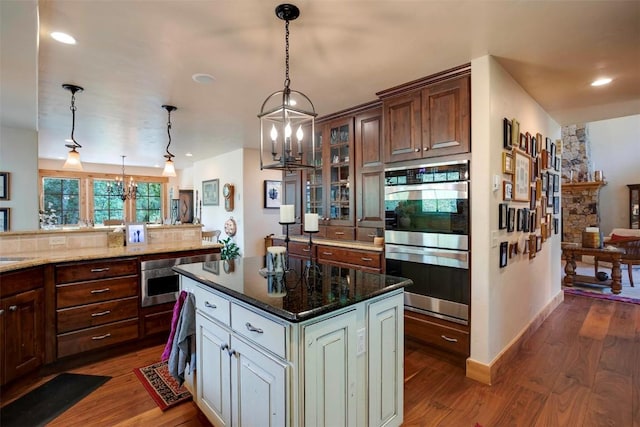 2415 Val Disere Cir, Steamboat Springs, CO 80487 - kitchen featuring double oven, a chandelier, glass insert cabinets, dark wood-style flooring, and recessed lighting