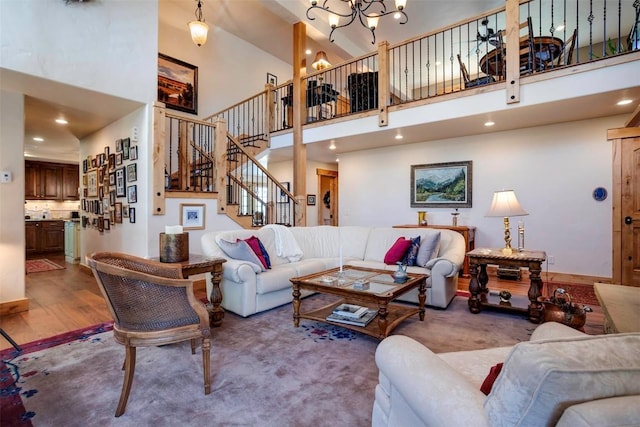 2415 Val Disere Cir, Steamboat Springs, CO 80487 - living area featuring a high ceiling, stairs, wood finished floors, a chandelier, and recessed lighting