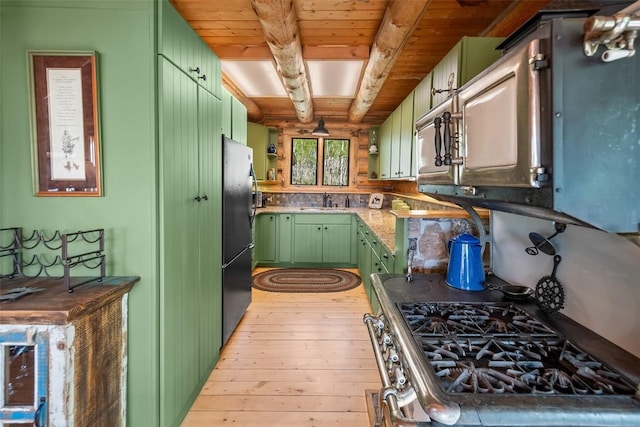 633 French Pass Cir, Jefferson, CO 80456 - kitchen with green cabinetry, freestanding refrigerator, light wood-type flooring, a wooden ceiling with exposed beams, and stainless steel gas range