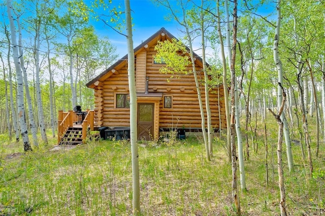 633 French Pass Cir, Jefferson, CO 80456 - rear view of house with log siding and a wooden deck