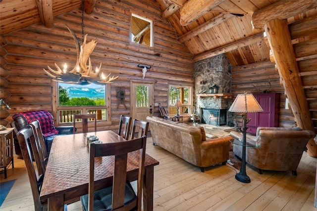 633 French Pass Cir, Jefferson, CO 80456 - dining room featuring rustic walls, a wood ceiling with exposed beams, light wood-type flooring, a chandelier, and high vaulted ceiling