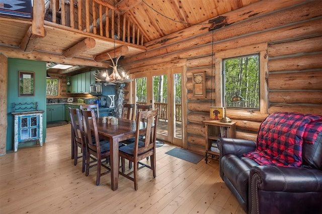 633 French Pass Cir, Jefferson, CO 80456 - dining space featuring a wooden ceiling with exposed beams, a chandelier, light wood finished floors, and rustic walls