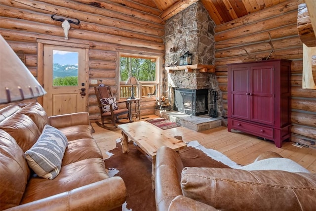 633 French Pass Cir, Jefferson, CO 80456 - living area with light wood-style flooring, wooden ceiling, a fireplace, lofted ceiling, and log walls