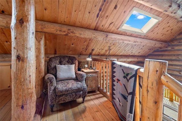 633 French Pass Cir, Jefferson, CO 80456 - sitting room with a skylight, rustic walls, a wood ceiling with exposed beams, and light wood-style floors