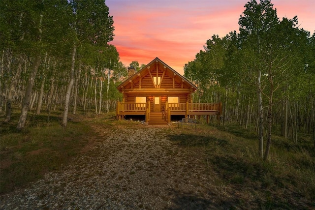 633 French Pass Cir, Jefferson, CO 80456 - view of front of home featuring a chimney, log siding, and a deck