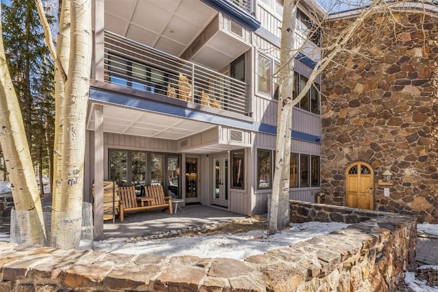 1203 W Keystone Rd Unit 2709, Keystone, CO 80435 - exterior space with stone siding, french doors, a balcony, and board and batten siding