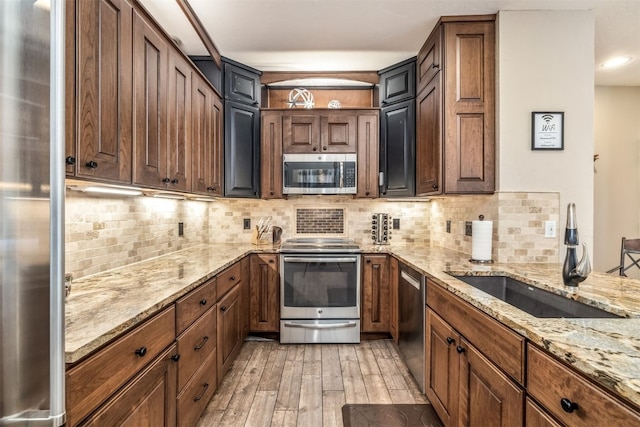 1203 W Keystone Rd Unit 2709, Keystone, CO 80435 - kitchen with tasteful backsplash, stainless steel appliances, light wood-type flooring, and a sink