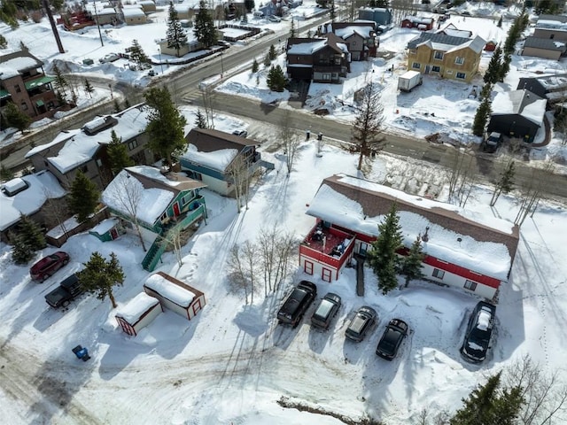snowy aerial view with a residential view