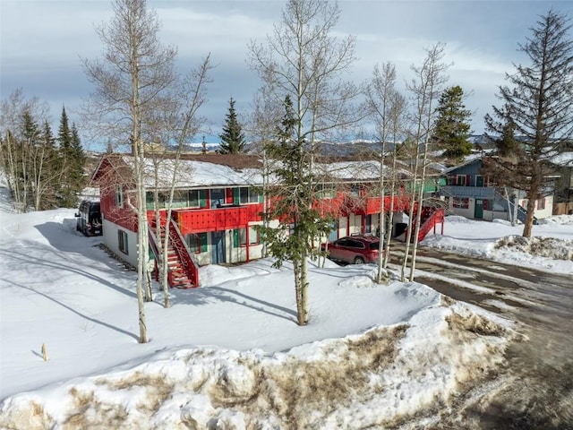 view of front of house with a wooden deck and stairs