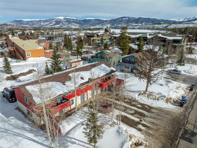 snowy aerial view with a residential view and a mountain view