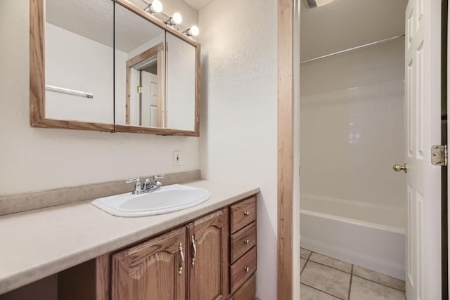bathroom featuring vanity, tile patterned flooring, and tub / shower combination