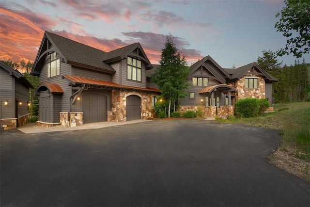 228 Cottonwood Cir, Breckenridge, CO 80424 - craftsman-style house featuring stone siding, driveway, and a garage
