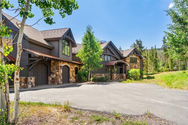 228 Cottonwood Cir, Breckenridge, CO 80424 - view of front of home with stone siding, asphalt driveway, and a shingled roof
