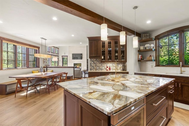 228 Cottonwood Cir, Breckenridge, CO 80424 - kitchen with plenty of natural light, decorative backsplash, light wood finished floors, recessed lighting, and beam ceiling