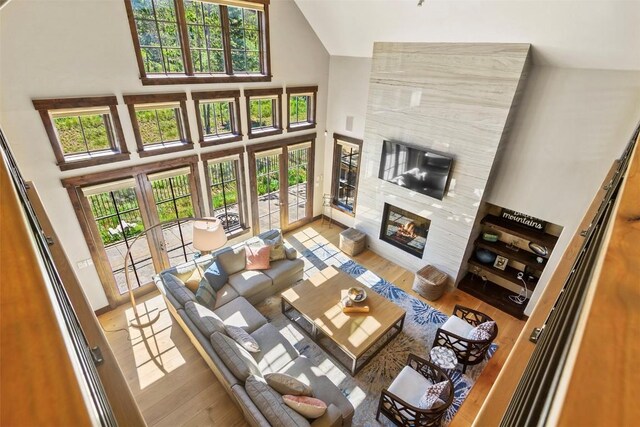 228 Cottonwood Cir, Breckenridge, CO 80424 - living area featuring high vaulted ceiling, wood finished floors, a premium fireplace, and french doors