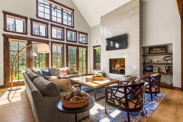 228 Cottonwood Cir, Breckenridge, CO 80424 - living room featuring high vaulted ceiling, hardwood / wood-style flooring, healthy amount of natural light, and a premium fireplace