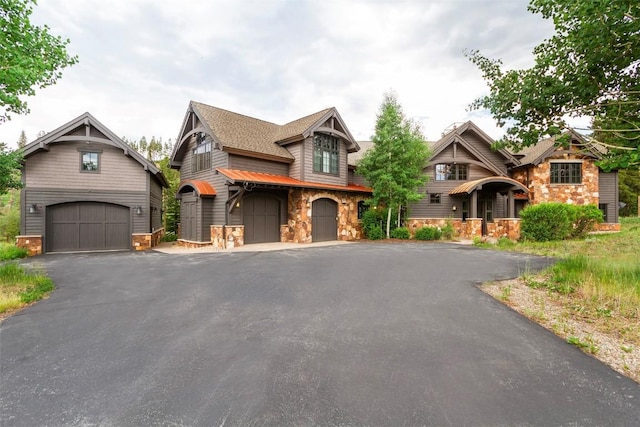 228 Cottonwood Cir, Breckenridge, CO 80424 - view of front facade with stone siding, driveway, and an attached garage
