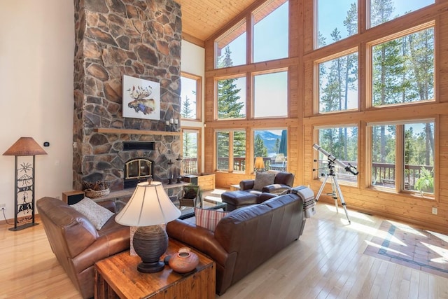 440 Gcr 466, Grand Lake, CO 80447 - living room featuring high vaulted ceiling, hardwood / wood-style flooring, a stone fireplace, wood ceiling, and baseboards
