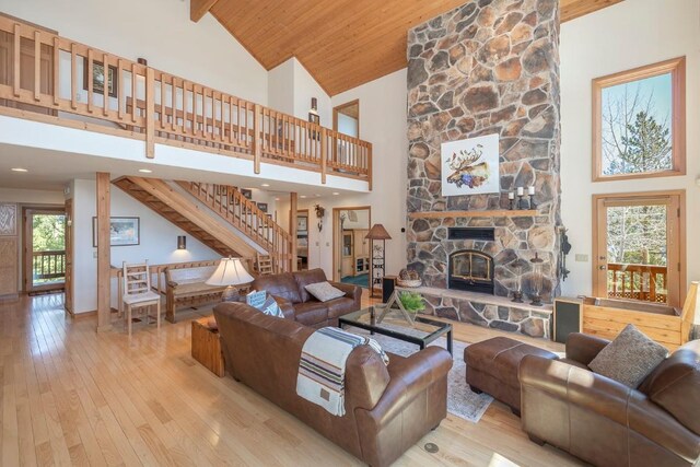 440 Gcr 466, Grand Lake, CO 80447 - living room featuring high vaulted ceiling, stairway, hardwood / wood-style flooring, a fireplace, and wood ceiling