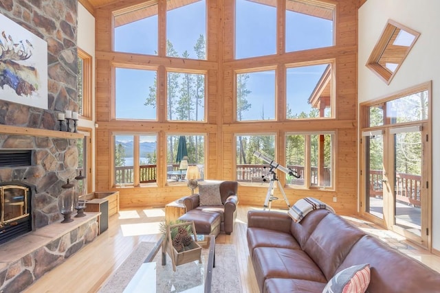 440 Gcr 466, Grand Lake, CO 80447 - living room featuring high vaulted ceiling, wood finished floors, healthy amount of natural light, wood walls, and a fireplace